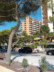 a car parked in a parking lot next to a building at Cristallo Residence in Lignano Sabbiadoro