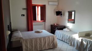 Postel nebo postele na pokoji v ubytování Hotel Borgo Antico