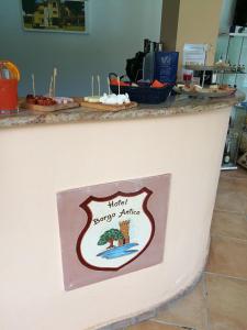 a sign that says hello happy surfing on a counter at Hotel Borgo Antico in San Severino