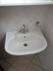 a bathroom sink with a faucet in a bathroom at Castello Azzurro in Agia Anna Naxos