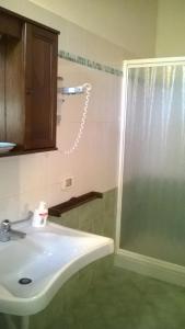 y baño con lavabo y ducha. en Turismo Rurale Baglio Fastuchera, en Alcamo