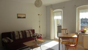 a living room with a couch and a table at Fewo Jahn in Bad Schandau