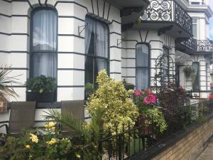 a house with flowers on the balcony at The Prince Guest House in Great Yarmouth