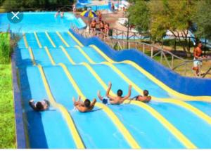 a group of people on a slide at a water park at Dolce Bungalow R5915 in Pula