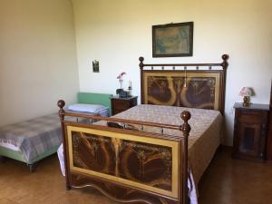 a bedroom with two beds and a table and a picture on the wall at Casa di Vittoria in Civitella in Val di Chiana