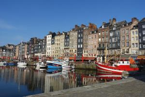 a group of boats docked in a harbor with buildings at Armonui Honfleur centre historique in Honfleur
