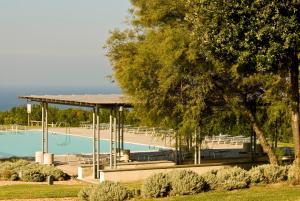 a swimming pool with a pavilion and a playground at Casale del Mare in Castiglioncello