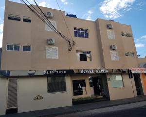 a building on the corner of a street at Hotel Alpha in Uberlândia