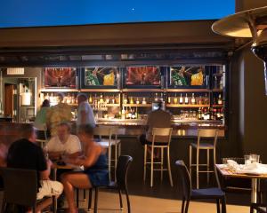 a group of people sitting at a bar at Padre Hotel in Bakersfield