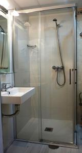 a bathroom with a shower and a sink at Hostal Forum in Villa del Río