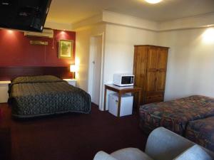 En eller flere senger på et rom på Palms Motel Footscray