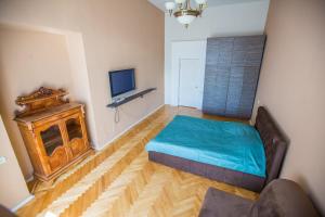 a bedroom with a bed and a tv on a wall at Aparts hub bridge in Saint Petersburg