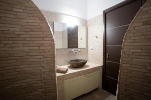a bathroom with a sink in a brick wall at Paros Central house in Parikia +17 photos