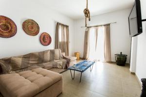a living room with a couch and a table at Paros Central house in Parikia