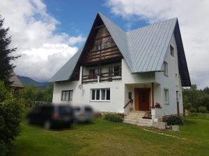a large white house with a gambrel roof at Vila Valéria in Tatranská Lomnica