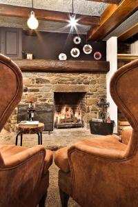 a living room filled with furniture and a fire place at Hostal Cisco de Sans in Andorra la Vella