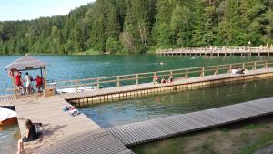 a dock with people on it in a lake at Verkių Namelis in Vilnius