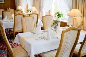 jadalnia ze stołami i krzesłami z białymi obrusami w obiekcie Hotel Haus Appel w mieście Rech