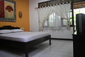 Postel nebo postele na pokoji v ubytování De Puspa Residence Seminyak + 37 fotografií