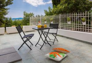 a patio with a table and chairs and a fence at "NM" Luxury apartments in Split