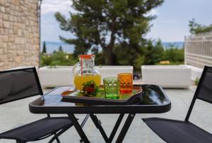 a tray of drinks on a table on a patio at "NM" Luxury apartments in Split