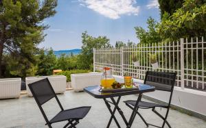 a patio table with two chairs and a pitcher of juice at "NM" Luxury apartments in Split