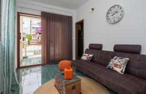 a living room with a couch and a clock on the wall at "NM" Luxury apartments in Split