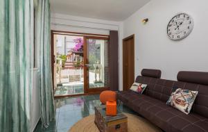 a living room with a couch and a clock on the wall at "NM" Luxury apartments in Split