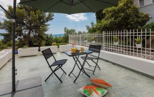 a patio with a table and chairs and an umbrella at "NM" Luxury apartments in Split