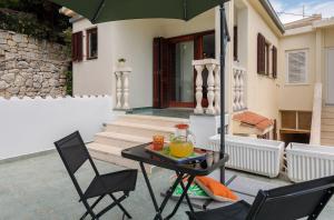 a table with a pitcher of orange juice sitting on a patio at "NM" Luxury apartments in Split