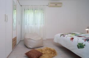 a white bedroom with a bed and a rug on the floor at "NM" Luxury apartments in Split