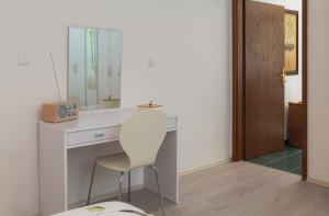 a white desk with a chair and a mirror at "NM" Luxury apartments in Split