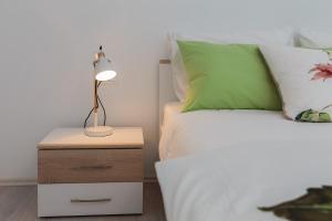 a bed with a night stand with a lamp on it at "NM" Luxury apartments in Split
