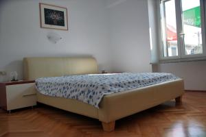 a bedroom with a bed in a room with a window at Tourist farm with Apartments Fig tree in Dekani