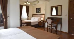 A bed or beds in a room at Zagnospasa Konaklari