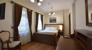 A bed or beds in a room at Zagnospasa Konaklari