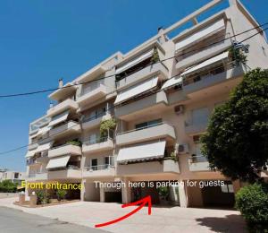 a building with a red arrow pointing to the front entrance at Beach apartment in Kalamata