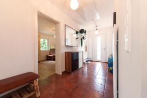 a living room with a tile floor and a fireplace at Haus am See in Döbriach