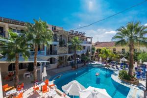 a large swimming pool in a tropical setting at Zante Plaza Hotel & Apartments in Laganas