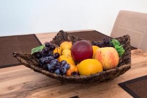 una cesta de fruta en una mesa de madera en Apartments Intrada, en Podstrana