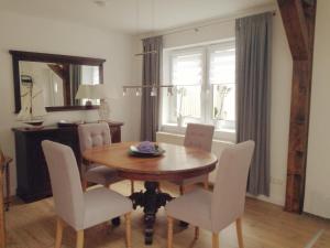 a dining room with a wooden table and chairs at Ferienhaus Schleeff in Elsfleth