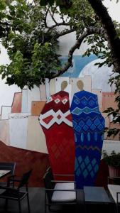 two vases are sitting next to a wall at Hotel Kostis in Skiathos Town