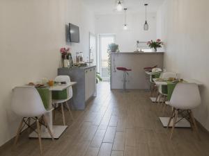 a kitchen and dining room with tables and chairs at Civico 1 in San Mauro Cilento