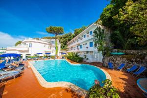 a swimming pool in front of a hotel at Bristol Hotel in Ischia