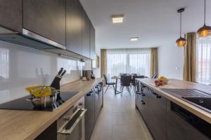 a kitchen with stainless steel appliances and a dining room at Pure Relax in Malinska