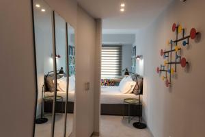 a bedroom with a bed and a mirror at Acropolis Monastiraki Newly Renovated Apartment in Athens