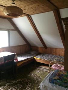 a room with two bunk beds in a attic at Chalupa Severak in Janov nad Nisou