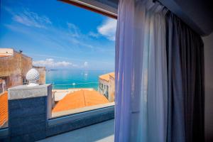a window with a view of the ocean at Ossuna Bay Hotel Boutique in Cefalù