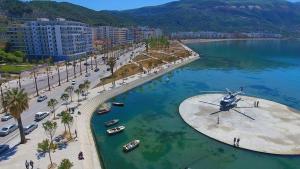 a helicopter is sitting in the water next to a beach at Cold Water Residence in Vlorë