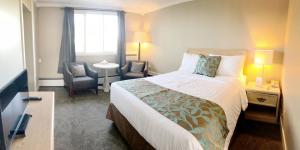 ein Hotelzimmer mit einem Bett und einem Stuhl in der Unterkunft Seasons Inn Halifax in Halifax
